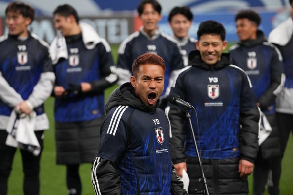 日本队在世界杯亚洲区预选赛中以 2-0 获胜后,长友佑都向球迷鼓掌,日本队获得 2026 年世界杯参赛资格