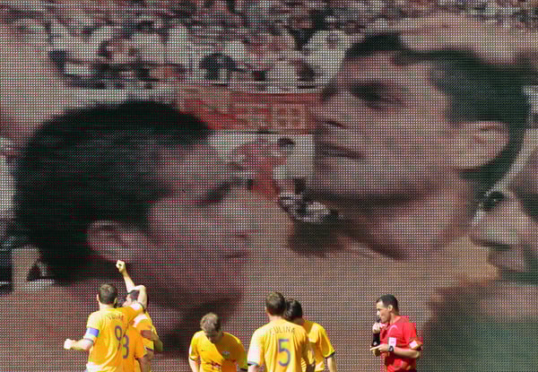 2006年国际足联世界杯期间，澳大利亚球员在约翰·阿洛伊西的照片前做出反应