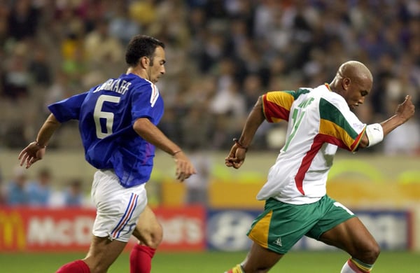 世界杯FIFA体育新闻:2002年世界杯上,法国球员尤里·德约卡夫追逐塞内加尔球员埃尔哈吉·迪乌夫